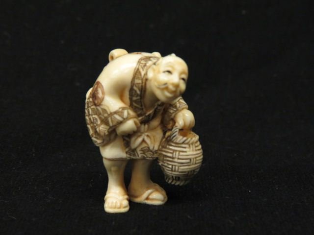 Carved Ivory Netsuke of an Old Man,: carrying a basket, fine polychrome work, 1 3/4", excellent.