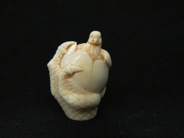 Carved Ivory Netsuke of a Chick: emerging from an egg, chicken feet or claw around it, signed, 1 3/4", excellent.