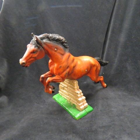 Hubley Cast Iron Figural Horse Figurine or Doorstop: of a jumper, two piece, all original, 9 3/4" tall, 14" long...The Hubley Manufacturing Company was first incorporated in 1894 in Lancaster, Pennsylvania by John Hubley. The first Hubley toys appeared 