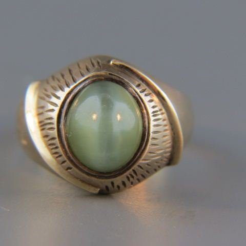 Cat's Eye Quartz Ring,: 4 carat green cabochon gem in 14k yellow gold, with appraisal of $875.00
