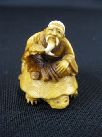 Carved Ivory Netsuke of a Bearded Man: and young boy on turtles back, signed, 1 1/2, excellent."