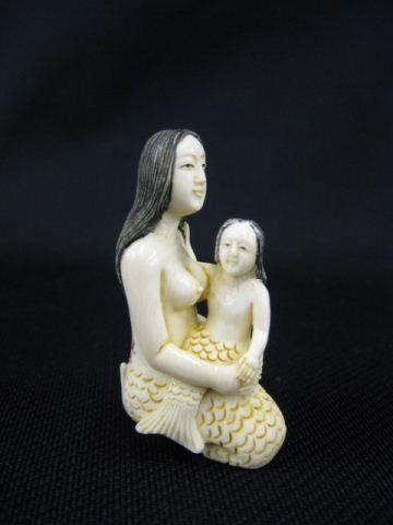Carved Ivory Netsuke of Seated Mermaid: holdup a mermaid child on her lap, signed, 27, excellent."