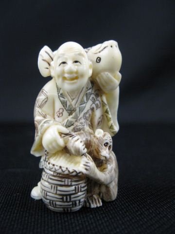 Carved Ivory Netsuke of a Man: with large fish on his back, monkey & basket at his feet, signed, 2, excellent."