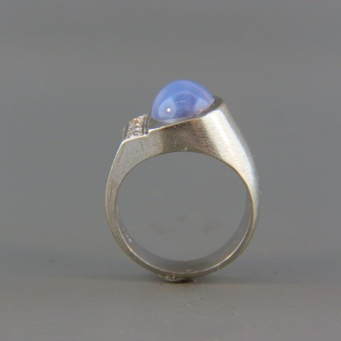 Diamond & Star Sapphire Ring,: blue cabuchon synthetic sapphire with four diamonds in side, 14k white gold.