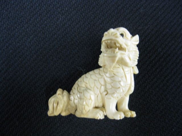 Carved Ivory Netsuke of a Seated Foo Dog,: onyx eyes, signed, 1 1/2, excellent."