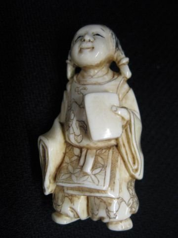 Carved Ivory Netsuke of a Young Girl,: holding a book, signed, 1 3/4, excellent."