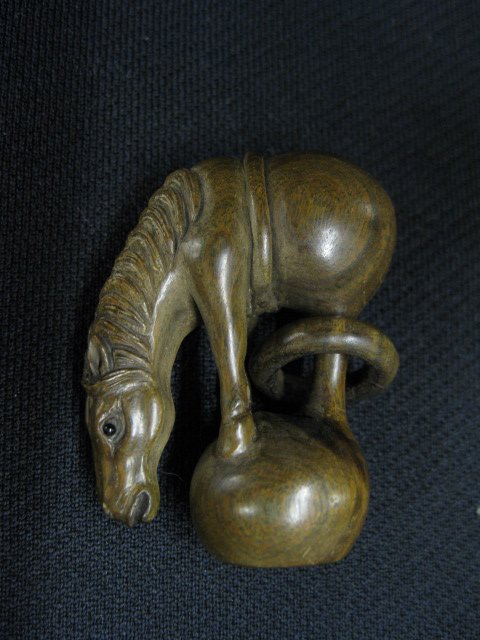 Carved Wood Netsuke of Horse,: standing on a ball, loose rag on leg, signed, 1 3/4, excellent."