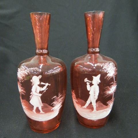 Pair of Mary Gregory Cranberry Art Glass Vases,: boy & girl with trumpets, 9 1/2"....The Amazing Tale of Mary Gregory When I first got wind of the legend surrounding glassware artist Mary Gregory, I heard a tale of a remarkable woman who hand painte