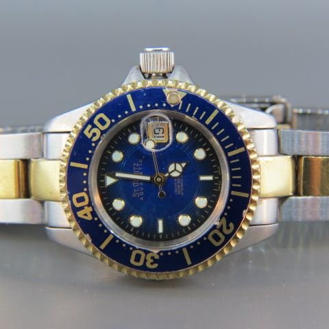 St. Moritz Stainless & Gold Wristwatch,: 25 jewels, blue dial and enamel bezel