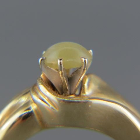 Cat's Eye Chrysoberyl & Diamond Ring,: 1.08 carat cabochon, rich honey color, 14 baguette diamonds totaling .33 carat in 14k yellow gold, with appraisal of $2350.00, currently size 8.