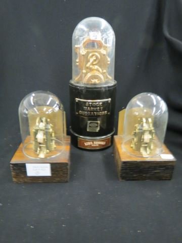 3 Example of Stock Ticker Machines,: pair of bookends and a Ezra Brooks figural decanter.