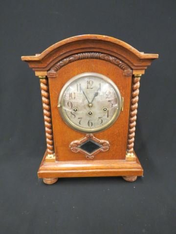 German Oak Bracket Clock,: twist columns beveled pedulum view, musical chimes, "Gebrauchsanweisung", 16 1/2" tall, working.