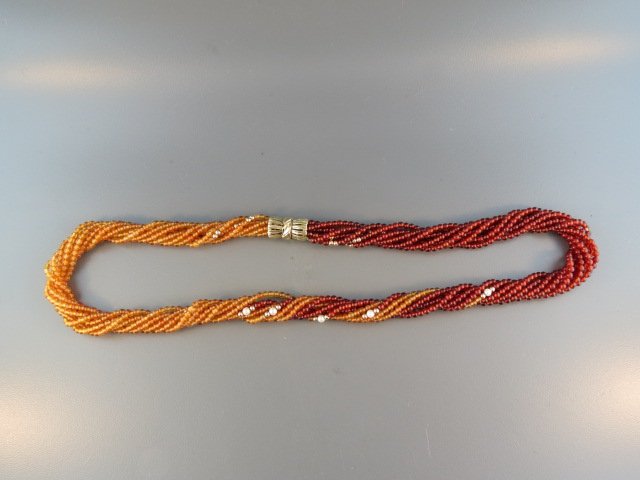 Carnelian Necklace,: 8 strand two tone beads, 14k gold and pearl spacers, 14k clasp, 16" long, with appraisal of $1,200.