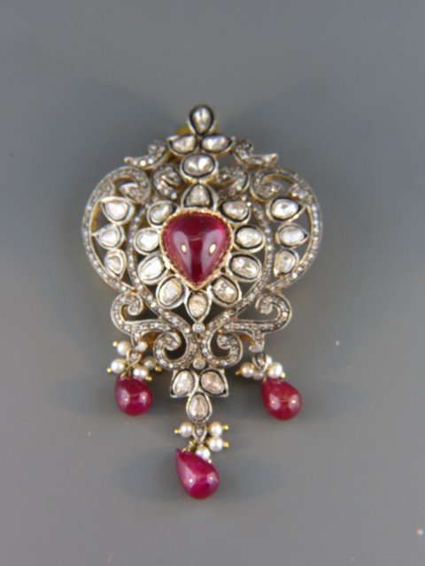 Ruby and Diamond Broach,: 4 rich red rubies total over 20 carats, 23 rose cut diamonds totaling 3.65 carats, 14k yellow gold and silver Mogul style setting, 2 3/4", with appraisal of $5,400.