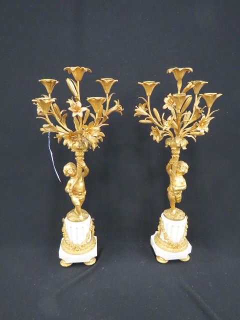 Pair of French Bronze Figural Candleabra,: putti holding up cornucopia, flowers emerging, carved marble bases, 24" tall, late 19th century.