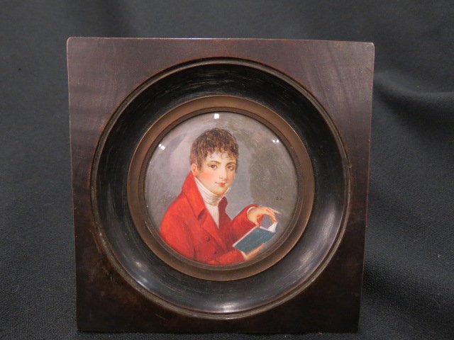 Miniature Painting on Ivory of Young Man Reading,: red coat, 3" diameter image, signed S.L., 19th century.