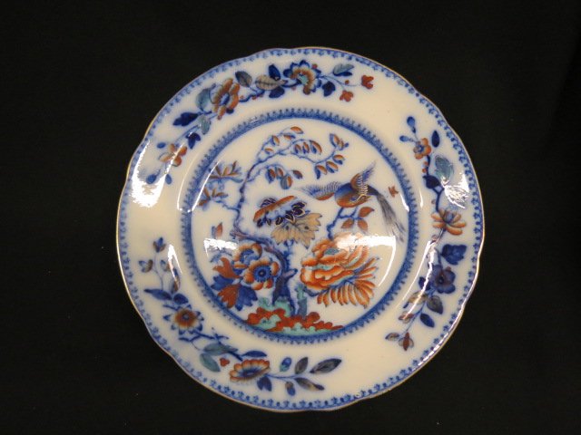 Early Davenport Ironstone Plate,: flow blue and poly chrome bird and floral, 10.5", excellent...John Davenport, born in 1765, is said to have begun potting in 1785, first as a workman, and later as a partner with Thomas Wolfe of Stoke
