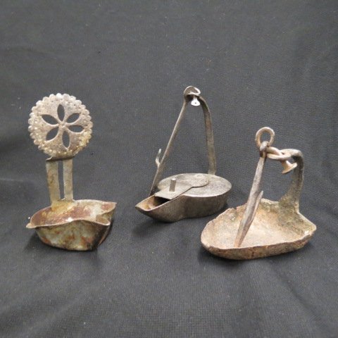 3 Early Betty or Crusie Lamps,: probably from Pennsylvania, 18th century....The Betty, from the German word "besser," meaning better, was designed to improve the performance of the lamps by creating a wicker holder in the base of th
