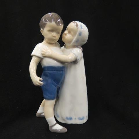 Bing and Grondahl Porcelain Figurine,: of young girl kissing a boy, #1614, 6.25"...Bing and Grondahl first opened in 1853. Frederick Vilhelm Grondahl, a young artist and sculptor, partnered with M.H. and J.H. Bing. The Bing brothers were s