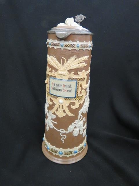 Mettlach Pottery Tankard,: raised flowering vine & wheat decor, bas-relief, brown field, #1737, 14 1/4", firing flaws around bottom of hadle at where it attatched, just drying lines, not repairs....Mettlach, Germany, is the cit