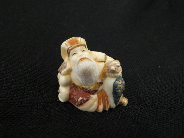 Carved Ivory Netsuke of a Seated Man, (1 of 4)