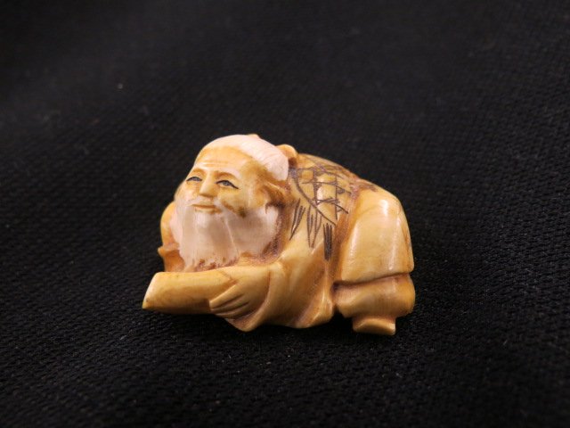 Carved Ivory Netsuke of an Old Man, (1 of 4)