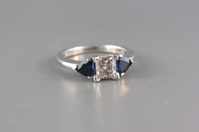 Diamond and Sapphire Ring,: 1 carat square diamond, fancy light brown, 2 triangle cut deep blue sapphire totaling 1 carat, 14k white gold, with appraisal of $2.250.00, currently size 6