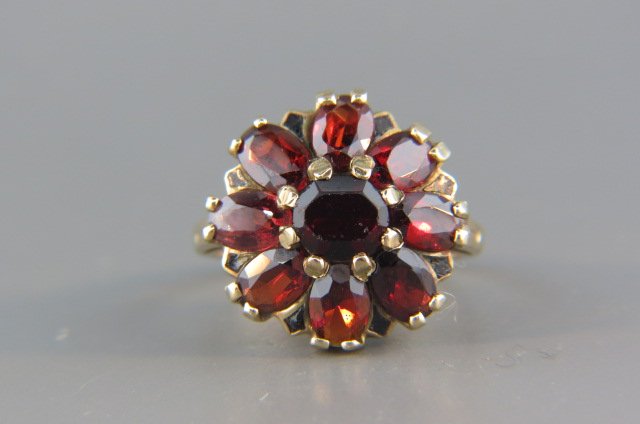 Garnet Ring,: 9 rich oval gems in 10k yellow gold, currently size 7.5.