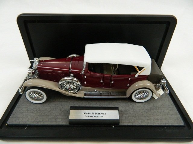 1930 Duesenberg J Derham Tourster 1:24 Franklin: Franklin Mint Precision Models This die cast up for auction is in great condition. The steering wheel turns the front wheels of the model car. The hoods and doors all open. The car still has its origi