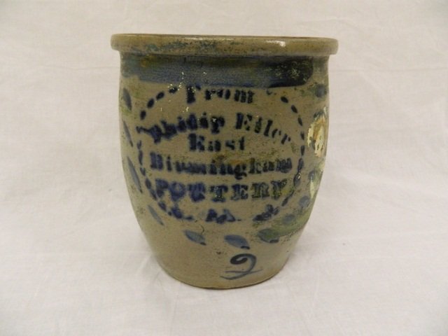 10" Eiler East Birmingham Stoneware Pottery Crock: H: 10" D: 8 1/2" A gallon size crock in Good Condition! Some of the paint has faded. Company labeled in blue on front with blue design framed around name. Muted colors of blue,green and taupe cover th