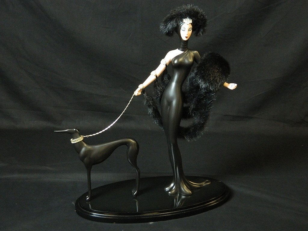 Erte Doll - Symphony in Black Lady & Dog: This piece is of The Franklin Heirloom Dolls collection called Symphony in Black crafted in fine hand-painted porcelain. It is embellished with Swarovski crystals, nice accents of platinum, a chain of