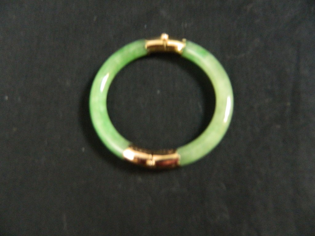 18K Gold and Jade Bracelet: We have for you a beautiful 18 K Gold Jade bracelet. 2 1/2 " in diameter closed. Great condition!!!
