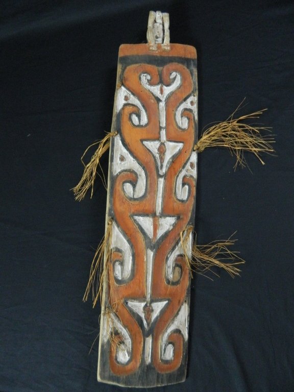 Papua New Guinea Ceremonial Dance Shield: #169 37" High, war shield intended for ceremonial use with ancestral figure on top, painted red white and black. From the Agats village,Asmat.