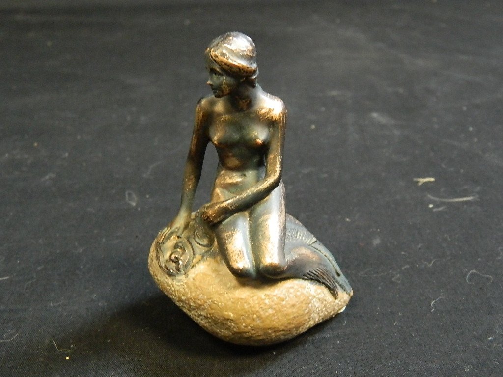 "little mermaid" from copenhagen: Sculpture of a mermaid sitting on rock sun bathing. Measures 3.75" H x 2.75" W.. the head of the original bronze in the harbor has been sawed off and stolen 3 times!!! this one has the head. ha ha thi