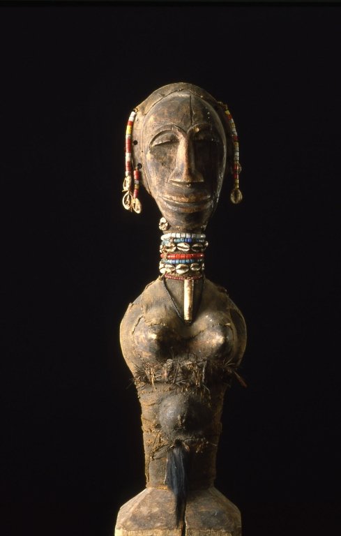 Oceanic/African Tribal Art Mali Fetish Figure: 23.5" High, female figure with turtle underbelly skin on her back, cowry shells, and a beaded necklace and earrings. The piece was in a private collection before 1960.