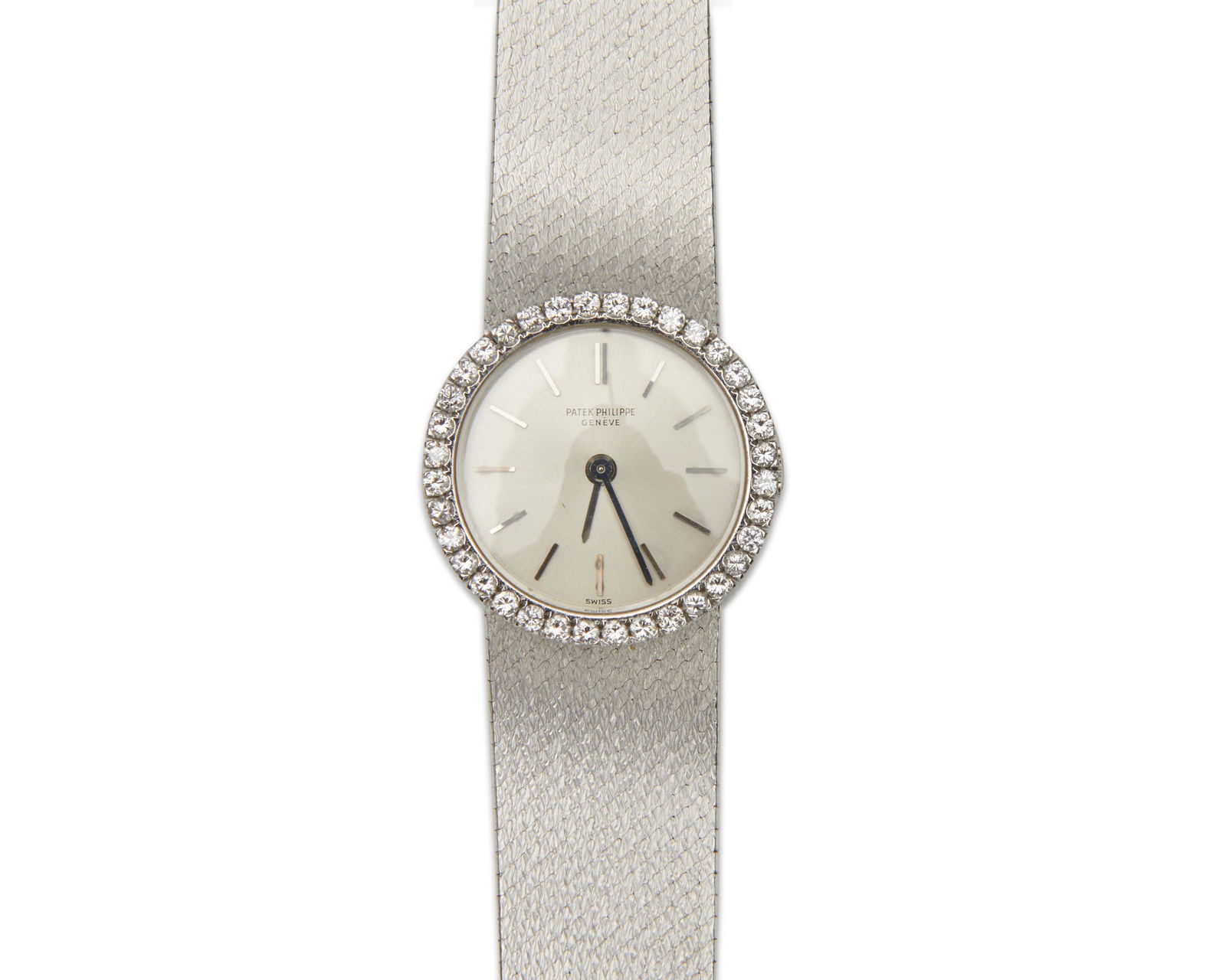 PATEK PHILIPPE 18K Gold and Diamond Wristwatch: PATEK PHILIPPE 18K Gold and Diamond Wristwatchthe silvered dial with applied baton numeral indicators; framed by a bezel of full-cut diamonds weighing approx. 0.75 tcw.; enclosing a manual wind moveme