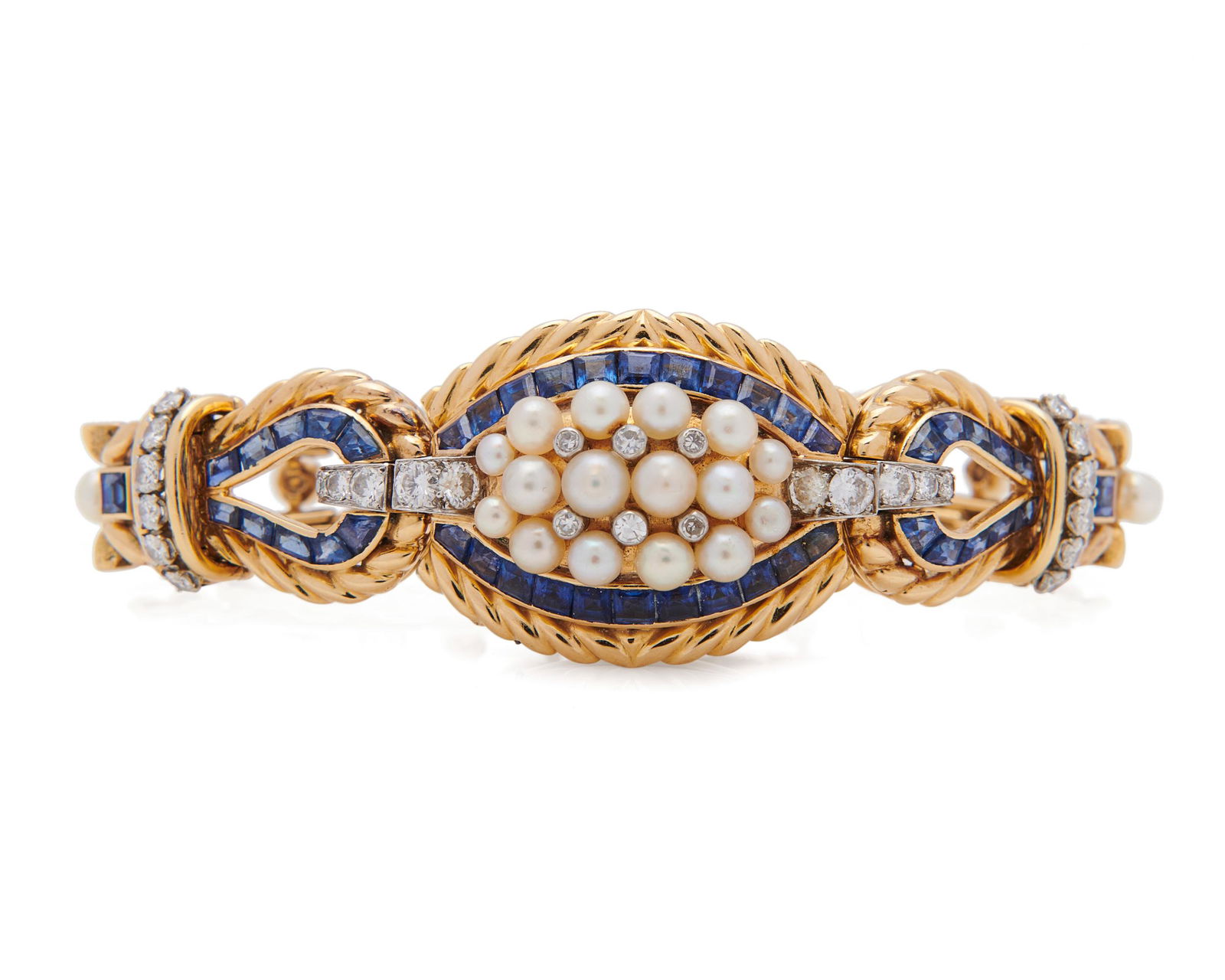 GÜBELIN 18K Gold, Sapphire, Pearl, and Diamond: GÜBELIN 18K Gold, Sapphire, Pearl, and Diamond Covered Wristwatchthe wristwatch covered by a cluster of pearls and full-cut diamonds framed by a row of channel-set step-cut sapphires lifting to r