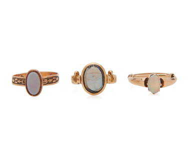 FRANK WALTER LAWRENCE Egyptian Revival Carved Opal Ring: FRANK WALTER LAWRENCE Egyptian Revival Carved Opal Ring and Two Other Ringsfeaturing a carved opal in the form of a scarab within an engraved gold mount, signed F.W.L; and an opal ring and a hardstone