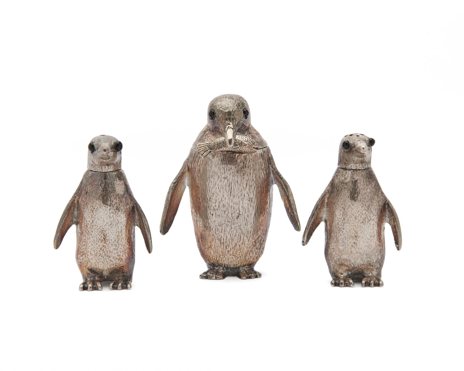 RICHARD COMYNS Silver Three Piece Penguin Cruet Set: RICHARD COMYNS Silver Three Piece Penguin Cruet SetLondon, ca. 1962-1970; the three detailed figures with black glass eyes, comprising: mustard with caught fish-form spoon visible in beak, salt, and p
