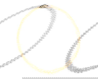 Natural Pearl and Diamond Necklace: Natural Pearl and Diamond Necklacecomprising two strands of 180 graduated near-round and button natural pearls measuring approx. 3.04 - 7.01 mm. completed by a silver-topped-gold and old European-cut