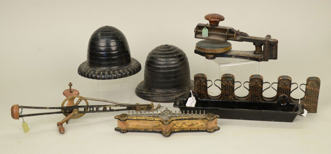 COLLECTION OF CAST IRON HOUSEHOLD ITEMS: COLLECTION OF CAST IRON HOUSEHOLD ITEMS, including: two beehive twine holders, an umbrella holder, a whist counter, a sewing implement, marked Ideal; and a press