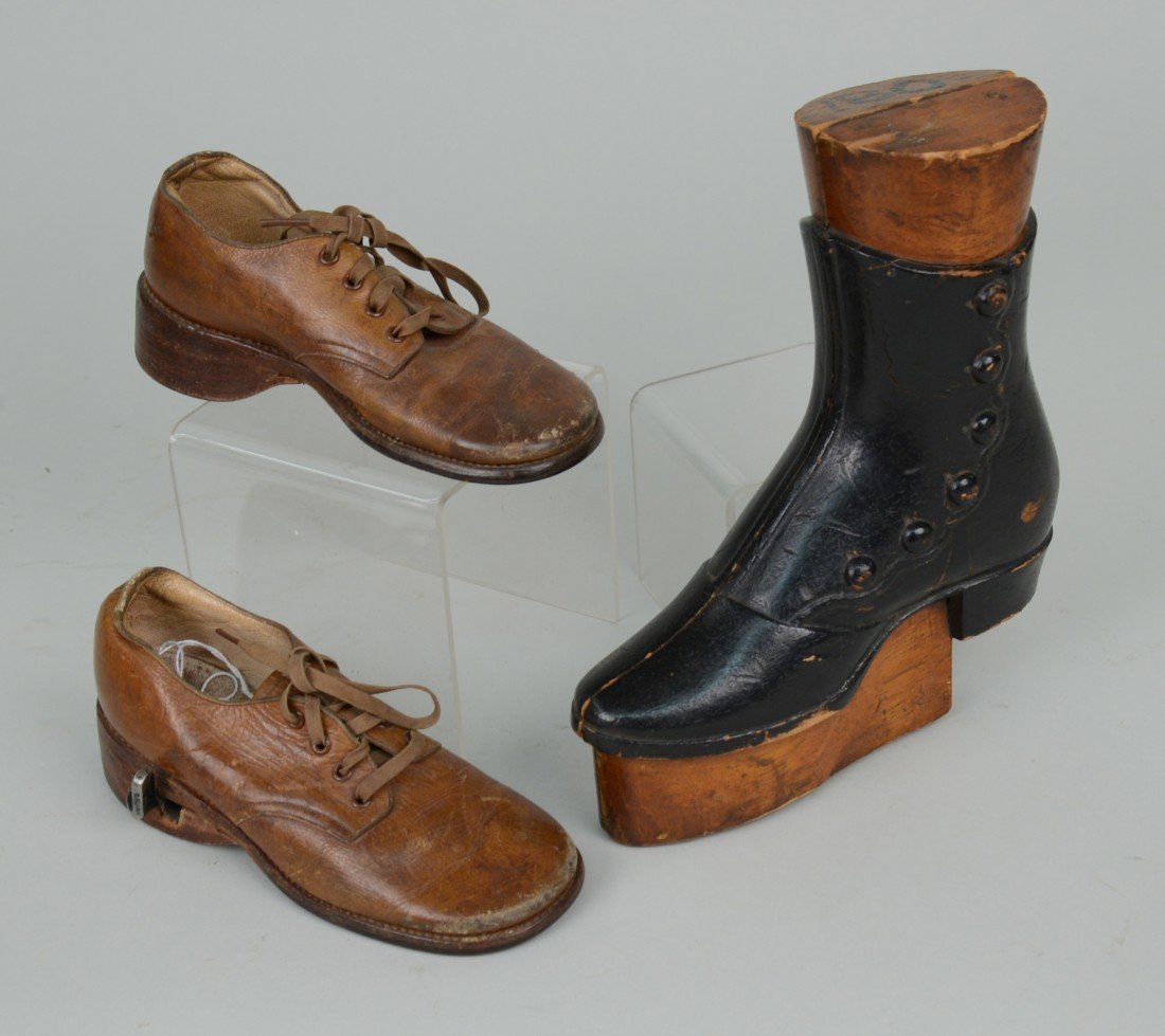 PAIR OF CHILD'S SHOES, with adjustable lift; and a CARV: PAIR OF CHILD'S SHOES, with adjustable lift; and a CARVED AND PAINTED WOOD LADIES BOOT SAMPLE