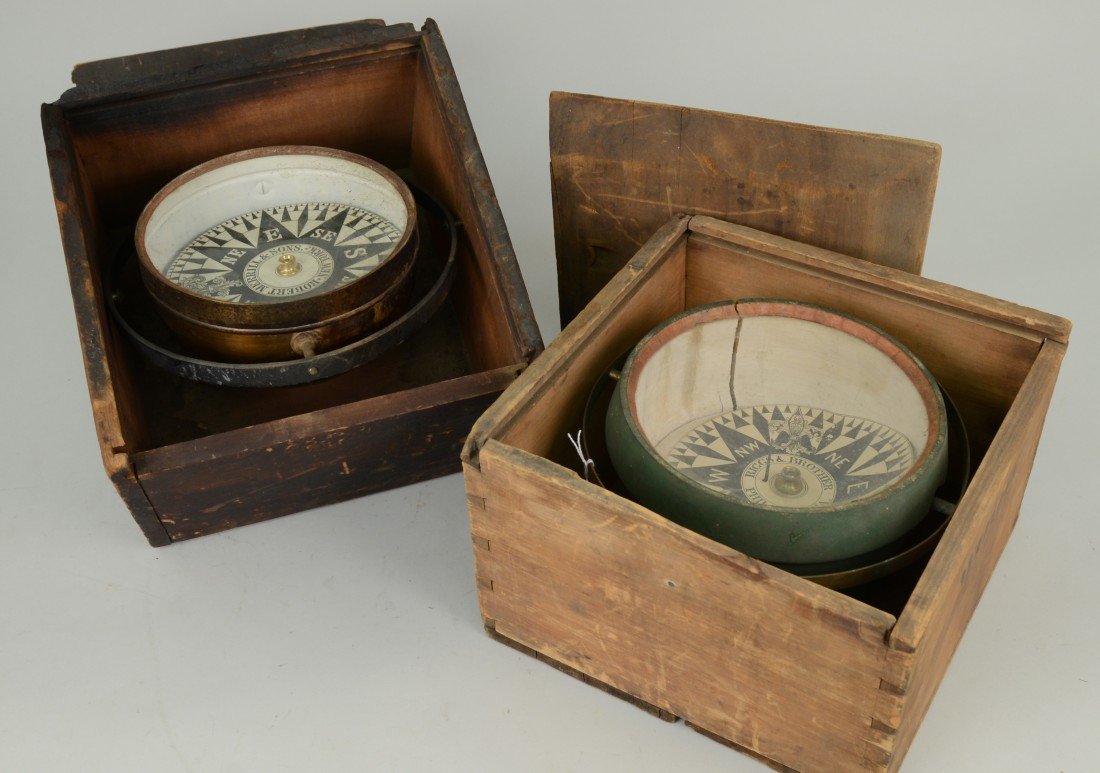 TWO DRY CARD COMPASSES, one Riggs & Brother, Philadelph: TWO DRY CARD COMPASSES, one Riggs & Brother, Philadelphia; the other, Robert Merrill & Sons, N.Y.; diameters: 7 inches; each in a fitted wood box