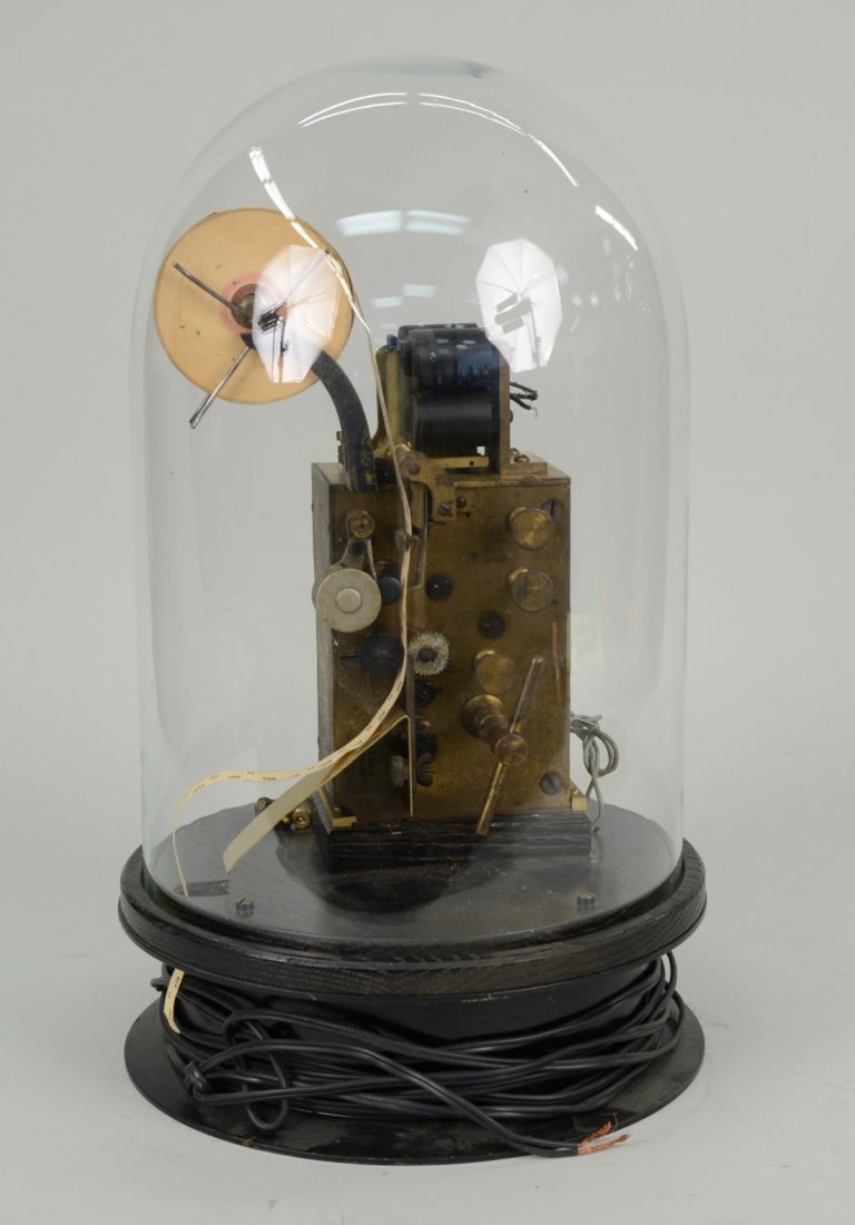TICKER TAPE MACHINE, mounted on an oak base with glass: TICKER TAPE MACHINE, mounted on an oak base with glass dome; together with a PEDESTAL marked: Bell Typewriter Services