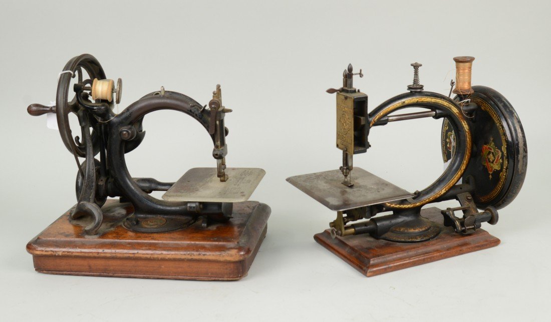 TWO HAND CRANKED CAST IRON SEWING MACHINES; including o: TWO HAND CRANKED CAST IRON SEWING MACHINES; including one marked 'The Improved Gresham', model No. 28296; and one marked Wilcox & Gibbs