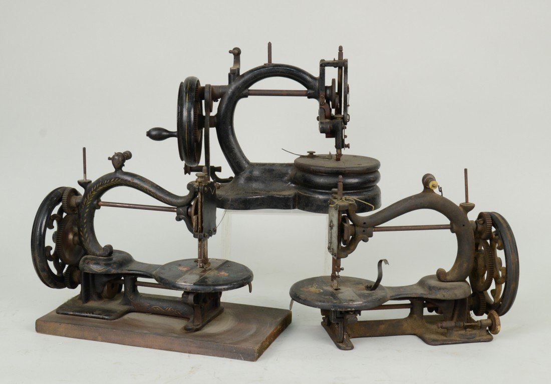 THREE CAST IRON SEWING MACHINES: THREE CAST IRON SEWING MACHINES