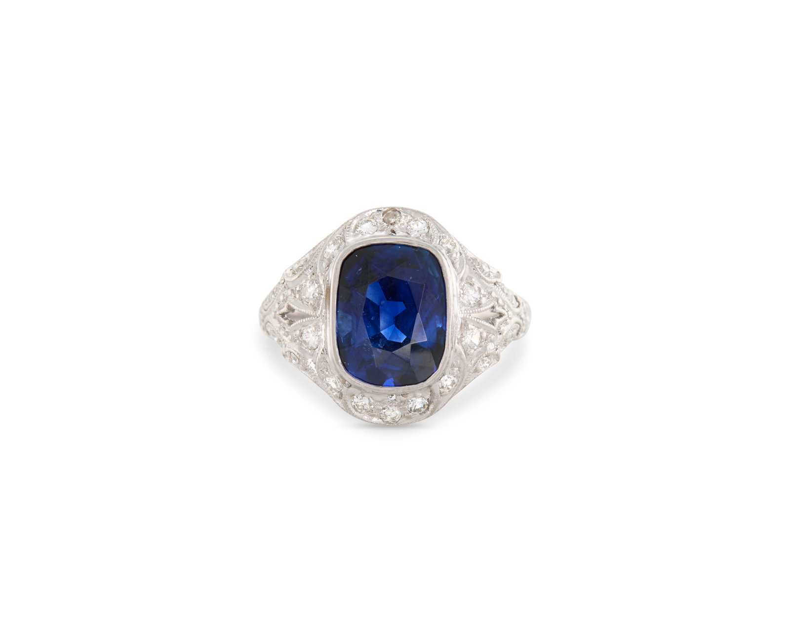 Platinum, Madagascar Sapphire, and Diamond Ring: Platinum, Madagascar Sapphire, and Diamond Ring centering a bezel-set cushion-cut sapphire weighing 4.11 cts. framed by bead-set full-cut diamonds weighing approx. 0.33 tcw. in an engraved platinum