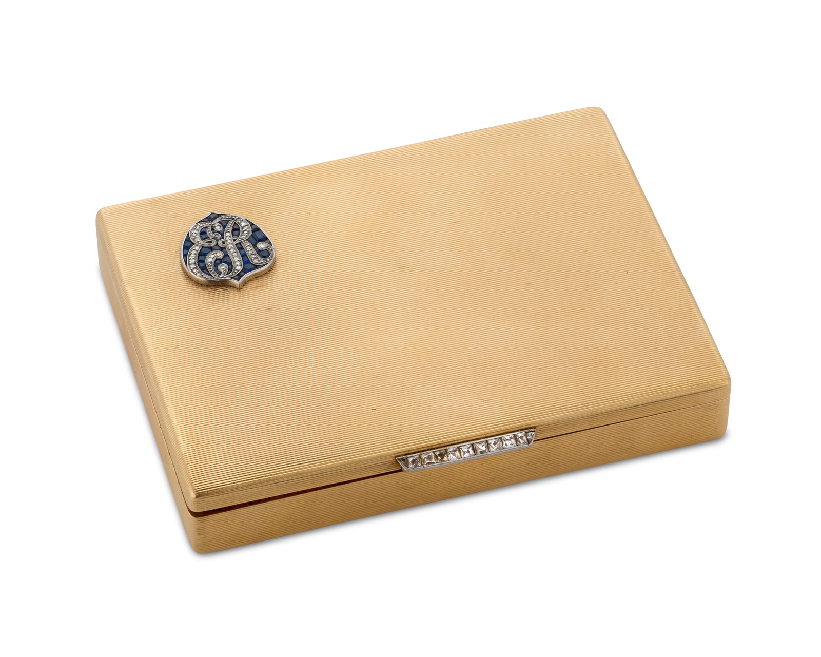 CARTIER 14K Gold, Sapphire, and Diamond Cigarette Case: CARTIER 14K Gold, Sapphire, and Diamond Cigarette Caseof fluted gold design featuring a crest set with step-cut sapphires and single-cut diamonds completed by a platinum clasp set with French-cut diam