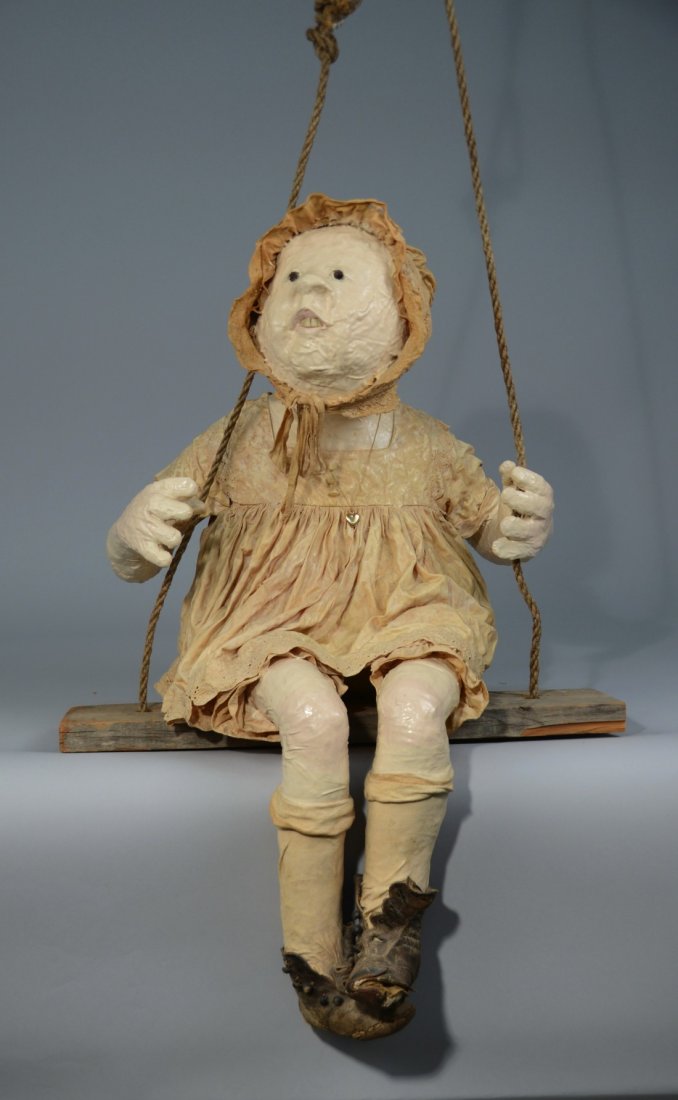 CAROL ANTHONY, (American, b. 1943), LITTLE MARY IN A SW: CAROL ANTHONY (American, b. 1943) LITTLE MARY IN A SWING paper-mache, fabric, wood, rope, and teeth; c.1969; 27 1/2 x 19 1/2 x 17 inches Provenance: Former Bequest of Tufts University.