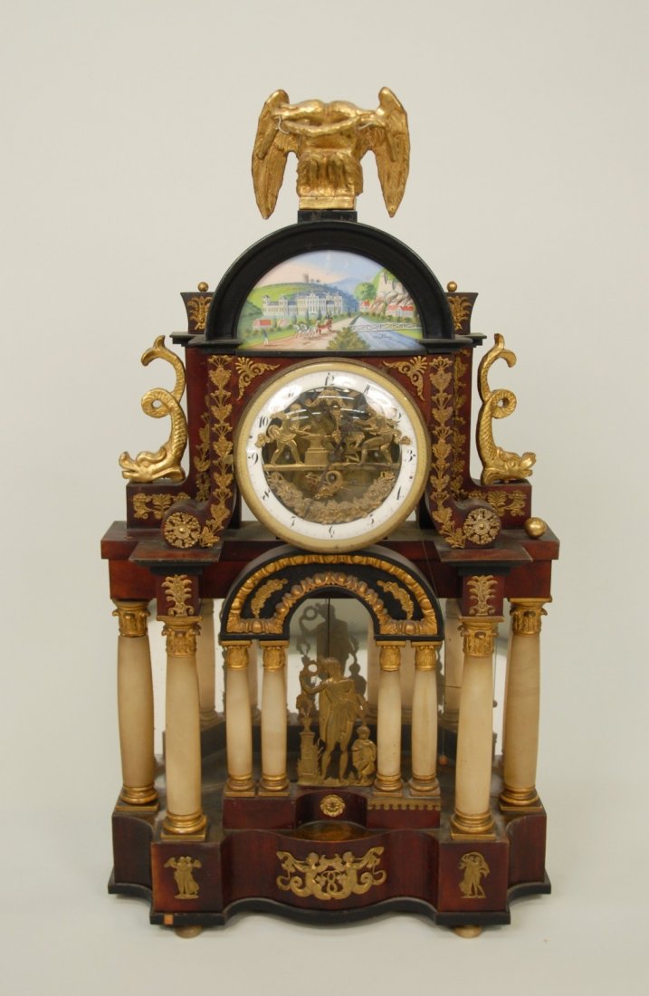 FANCIFUL AUSTRIAN BIEDERMEIER FRUITWOOD AND ALABASTER O: FANCIFUL AUSTRIAN BIEDERMEIER FRUITWOOD AND ALABASTER ORMOLU MOUNTED MANTLE CLOCK OF ARCHITECTURAL FORM, circa 1810; with automaton dial and carved giltwood double headed eagle finial; height: 33 inch